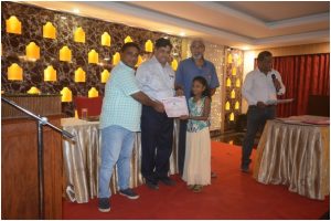 Children receiving Merit Certificates from President G.Bhaskar, Sh Lanka Ravi and ShPrasad,Vice President ANCA